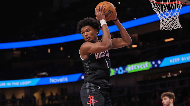 Jan 28, 2025; Atlanta, Georgia, USA; Houston Rockets forward Amen Thompson (1) grabs a rebound against the Atlanta Hawks in the first quarter at State Farm Arena. Mandatory Credit: Brett Davis-Imagn Images