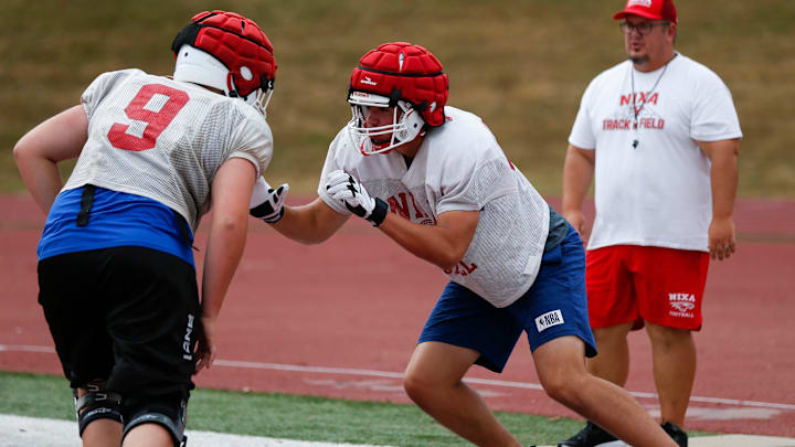 Nixa High School freshman Jackson Cantwell (right) runs drills during football practice on Tuesday, July 12, 2022. Cantwell is 6-foot-8 and a multi-sport athlete and also scored a 33 on the ACT.

Tnixa Football00048