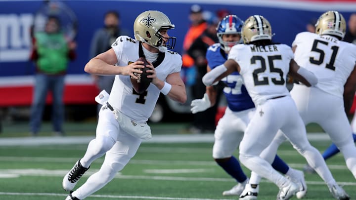 Dec 8, 2024; East Rutherford, New Jersey, USA; New Orleans Saints quarterback Derek Carr (4) looks to pass against the New York Giants during the first quarter at MetLife Stadium. Mandatory Credit: Brad Penner-Imagn Images