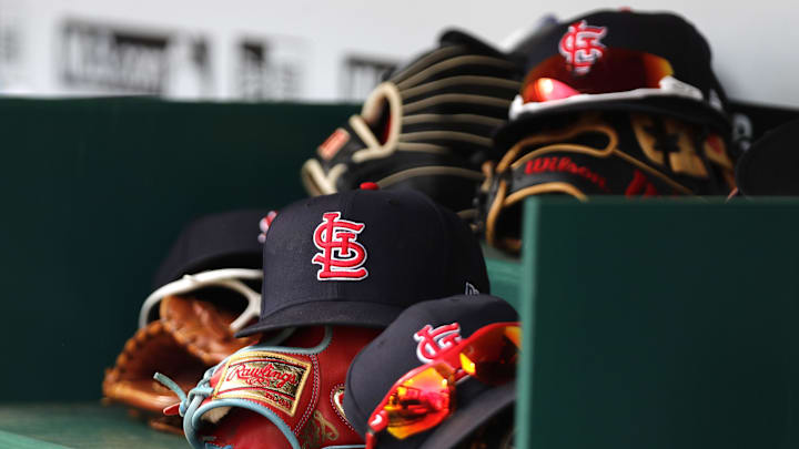 Apr 24, 2022; Cincinnati, Ohio, USA; A view of St. Louis Cardinals players    hats and gloves in the dugout during a game with the Cincinnati Reds at Great American Ball Park. Mandatory Credit: David Kohl-Imagn Images