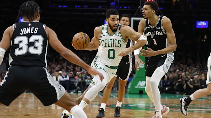Boston Celtics forward Jayson Tatum (0) drives past San Antonio Spurs center Victor Wembanyama (1) during the second quarter at TD Garden. Mandatory Credit: Winslow Townson-Imagn Images