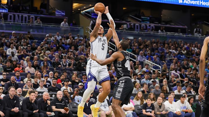 Orlando Magic forward Paolo Banchero (5) shoots over San Antonio Spurs forward Harrison Barnes (40) during the first quarter at Kia Center.