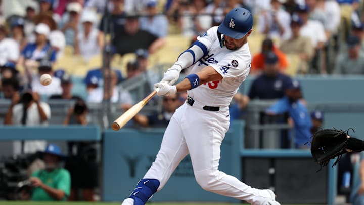 Sep 21, 2025; Los Angeles, California, USA;  Los Angeles Dodgers left fielder Michael Conforto (23) hits an RBI single during the seventh inning against the San Francisco Giants at Dodger Stadium. Mandatory Credit: Kiyoshi Mio-Imagn Images