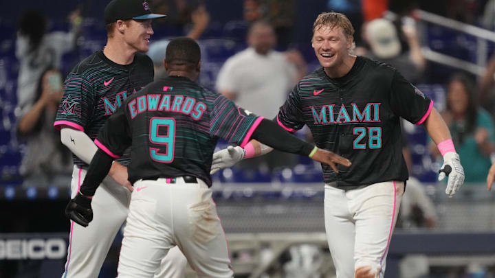 May 3, 2025; Miami, Florida, USA;  Miami Marlins right fielder Kyle Stowers (28) celebrates his walk-off grand slam in the ninth inning against the Oakland Athletics with shortstop Xavier Edwards (9) and first baseman Eric Wagaman (33) at loanDepot Park. Mandatory Credit: Jim Rassol-Imagn Images