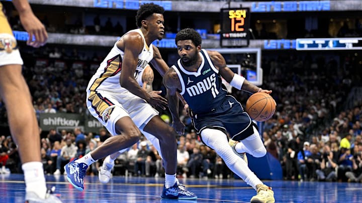 Nov 19, 2024; Dallas, Texas, USA; Dallas Mavericks guard Kyrie Irving (11) drives to the basket past New Orleans Pelicans center Yves Missi (21) during the second half at the American Airlines Center. Mandatory Credit: Jerome Miron-Imagn Images