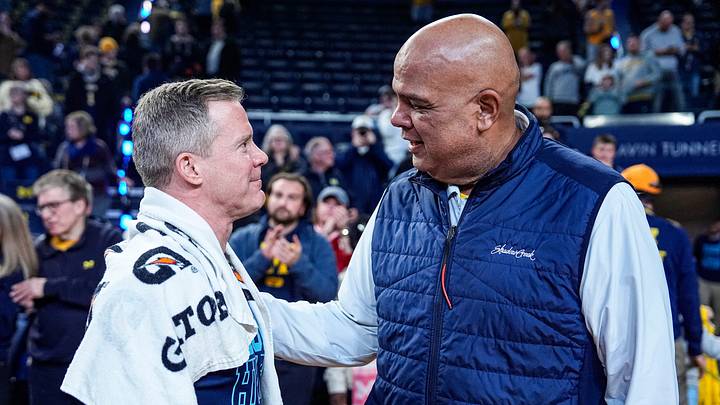 Michigan head coach Dusty May, left, is congratulated by athletic director Warde Manuel after 75-72 win over Nebraska at Crisler Center in Ann Arbor on Tuesday, Jan. 27, 2026.