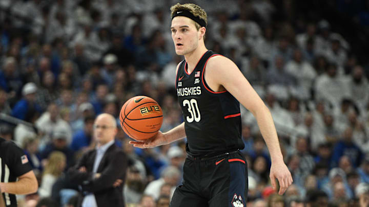 Feb 11, 2025; Omaha, Nebraska, USA;  Connecticut Huskies forward Liam McNeeley (30) dribbles against the Creighton Bluejays during the first half at CHI Health Center Omaha. Mandatory Credit: Steven Branscombe-Imagn Images