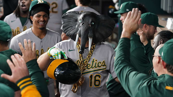 Apr 24, 2026; Arlington, Texas, USA;  Athletics first baseman Nick Kurtz (16) is greeted in the dugout with an elephant necklace and mask after hitting a solo home run during the first inning against the Texas Rangers at Globe Life Field. Mandatory Credit: Raymond Carlin III-Imagn Images
