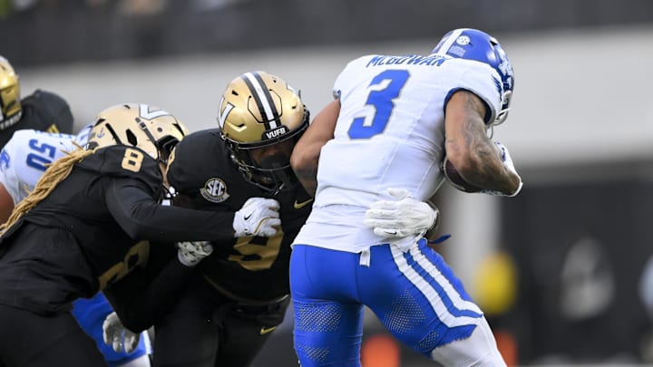 Nov 22, 2025; Nashville, Tennessee, USA;  Vanderbilt Commodores edge Keanu Koht (9) tackles Kentucky Wildcats running back Seth McGowan (3) for loss during the first half at FirstBank Stadium. Mandatory Credit: Steve Roberts-Imagn Images