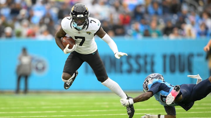 Dec 8, 2024; Nashville, Tennessee, USA;   Jacksonville Jaguars wide receiver Brian Thomas Jr. (7) breaks the tackle of Tennessee Titans cornerback Jarvis Brownlee Jr. (29) during the second half at Nissan Stadium. Mandatory Credit: Steve Roberts-Imagn Images