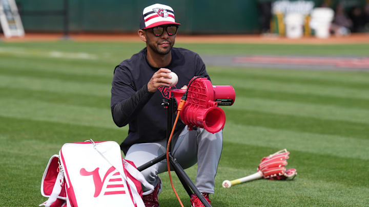 Mar 30, 2024: Cleveland Guardians major league field coordinator Kai Correa works on the field before the game against the Oakland Athletics at Oakland-Alameda County Coliseum. 