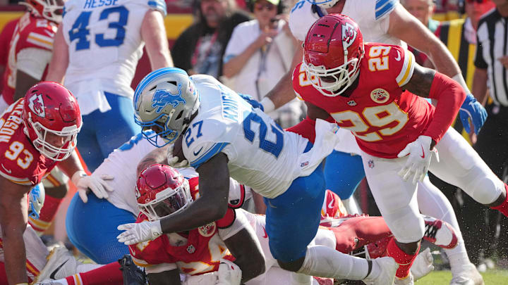 Aug 17, 2024; Kansas City, Missouri, USA; Detroit Lions running back Zonovan Knight (27) runs the ball as Kansas City Chiefs linebacker Curtis Jacobs (29) defends during the second half at GEHA Field at Arrowhead Stadium. Mandatory Credit: Denny Medley-Imagn Images
