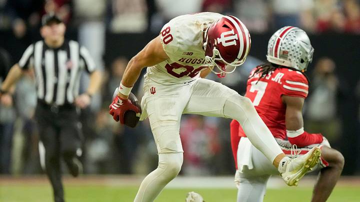 Indiana Hoosiers wide receiver Charlie Becker (80) celebrates after making a catch in front of Ohio State Buckeyes cornerback Jermaine Mathews Jr. (7) on Sunday, Dec. 7, 2025, during the Big Ten football championship at Lucas Oil Stadium in Indianapolis.