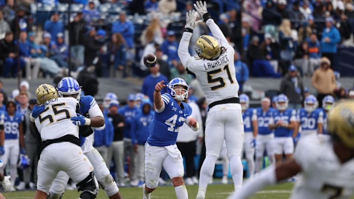 Nov 29, 2025; Provo, Utah, USA; BYU Cougars quarterback Bear Bachmeier (47) throws over the reach of UCF Knights defensive end Malachi Lawrence (51) during the second half at LaVell Edwards Stadium. Mandatory Credit: Rob Gray-Imagn Images