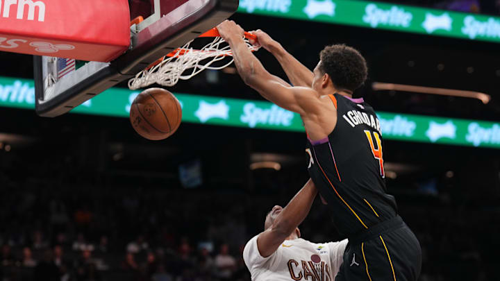 Mar 21, 2025; Phoenix, Arizona, USA; Phoenix Suns center Oso Ighodaro (4) dunks over Cleveland Cavaliers guard Darius Garland (10) during the second half at Footprint Center. Mandatory Credit: Joe Camporeale-Imagn Images