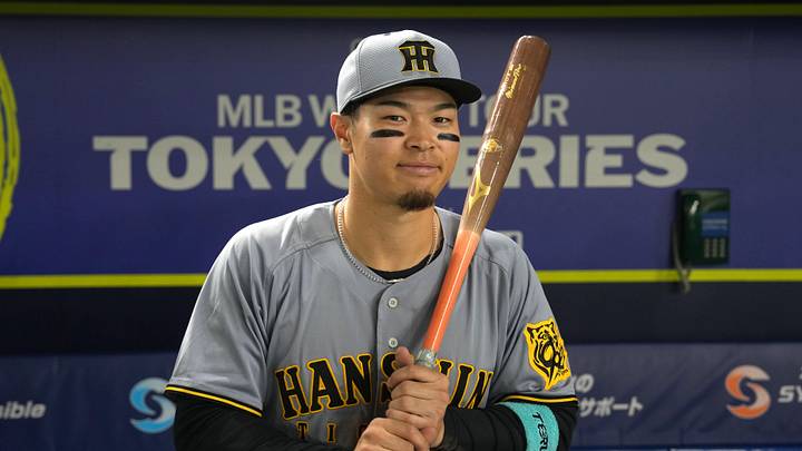 Mar 15, 2025; Bunkyo, Tokyo, Japan; Hanshin Tigers right fielder Teruaki Sato (8) poses for a photo after defeating the Chicago Cubs at Tokyo Dome. Mandatory Credit: Darren Yamashita-Imagn Images Mar 15, 2025; Bunkyo, Tokyo, Japan; Hanshin Tigers right fielder Teruaki Sato (8) poses for a photo after defeating the Chicago Cubs at Tokyo Dome. Mandatory Credit: Darren Yamashita-Imagn Images