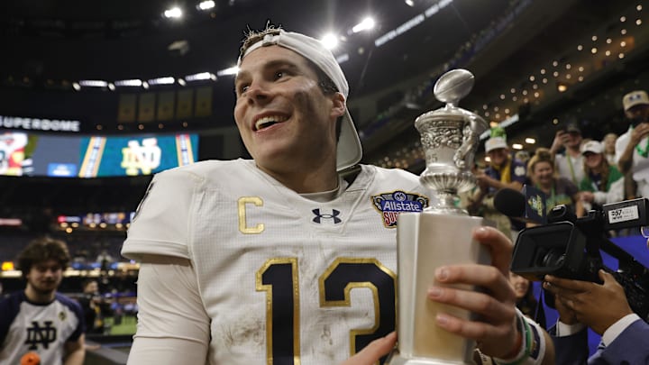 Notre Dame Fighting Irish quarterback Riley Leonard (13) celebrates with fans in the stands after defeating the Georgia Bulldogs at Caesars Superdome. Notre Dame Fighting Irish quarterback Riley Leonard (13) celebrates with fans in the stands after defeating the Georgia Bulldogs at Caesars Superdome.