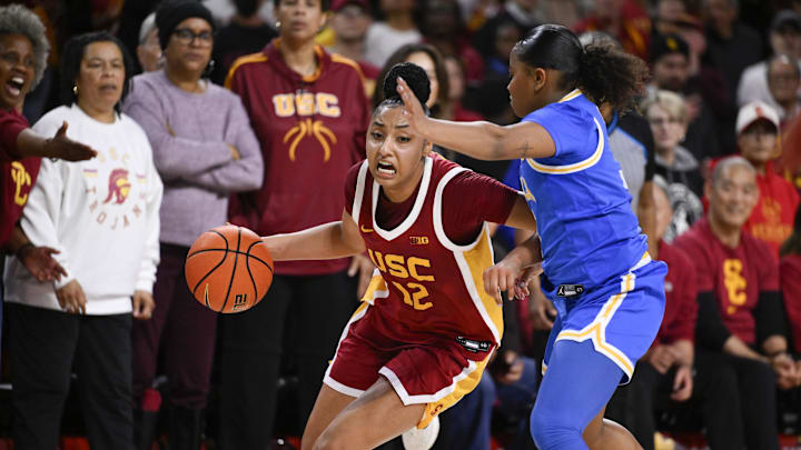 Feb 13, 2025; Los Angeles, California, USA; USC Trojans guard JuJu Watkins (12) dribbles against UCLA Bruins guard Londynn Jones (3) during the fourth quarter at Galen Center. Mandatory Credit: Robert Hanashiro-Imagn Images