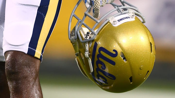 Sep 25, 2014; Tempe, AZ, USA; Detailed view of a UCLA Bruins helmet in the hand of a player against