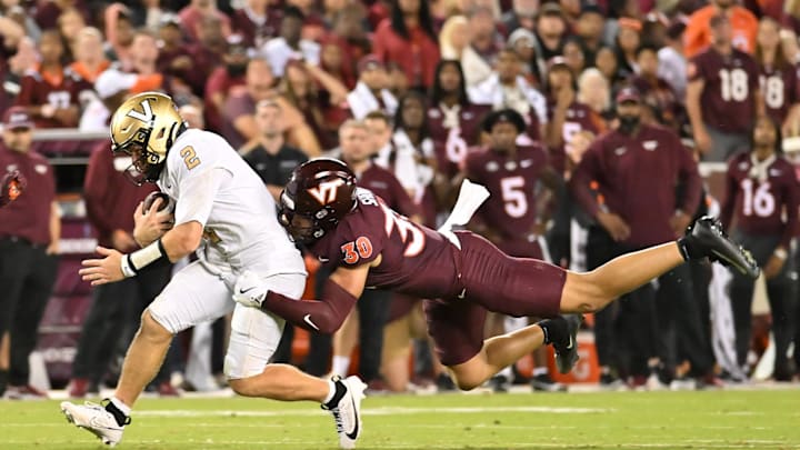 Sep 6, 2025; Blacksburg, Va.; Virginia Tech linebacker Michael Short (30) tackles Vanderbilt quarterback Diego Pavia (2).