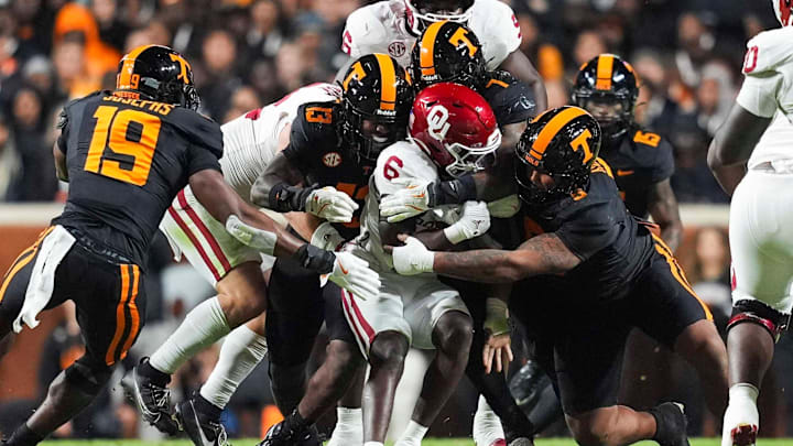Oklahoma running back Tory Blaylock (6) is warmped by Tennessee linebacker Edwin Spillman (13), Tennessee linebacker Arion Carter (7) and Tennessee defensive lineman Daevin Hobbs (5) during a NCAA football game between the Tennessee Volunteers and Oklahoma Sooners at Neyland Stadium in Knoxville, Tenn., on November 1, 2025. Oklahoma running back Tory Blaylock (6) is warmped by Tennessee linebacker Edwin Spillman (13), Tennessee linebacker Arion Carter (7) and Tennessee defensive lineman Daevin Hobbs (5) during a NCAA football game between the Tennessee Volunteers and Oklahoma Sooners at Neyland Stadium in Knoxville, Tenn., on November 1, 2025.