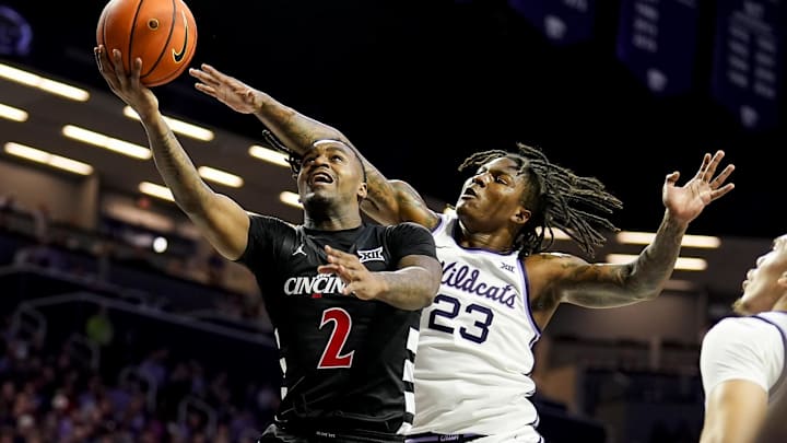 Dec 30, 2024; Manhattan, Kansas, USA; Cincinnati Bearcats guard Jizzle James (2) shoots against Kansas State Wildcats guard Macaleab Rich (23) during the first half at Bramlage Coliseum. Mandatory Credit: Jay Biggerstaff-Imagn Images
