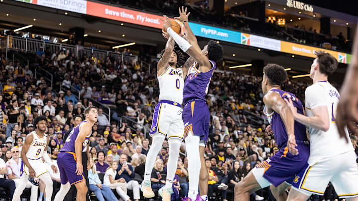 Oct 6, 2024; Palm Desert, California, USA; Los Angeles Lakers guard Jalen Hood-Schifino (0) shoots the ball against the Phoenix Suns during the second half at Acrisure Arena. Mandatory Credit: David Frerker-Imagn Images