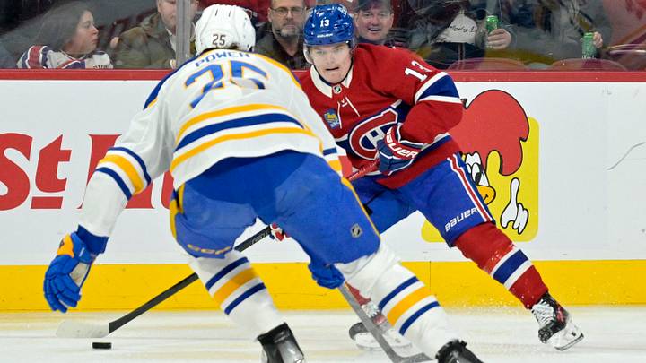 Mar 3, 2025; Montreal, Quebec, CAN; Montreal Canadiens forward Cole Caufield (13) plays the puck and Buffalo Sabres defenseman Owen Power (25) defends during the second period at the Bell Centre. Mandatory Credit: Eric Bolte-Imagn Images