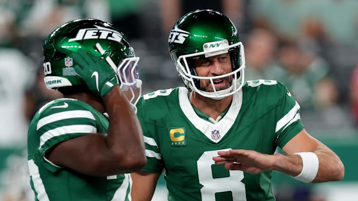 Sep 19, 2024; East Rutherford, New Jersey, USA; New York Jets quarterback Aaron Rodgers (8) talks to running back Breece Hall (20) during warmups before a game against the New England Patriots at MetLife Stadium. Mandatory Credit: Brad Penner-Imagn Images