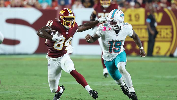 Washington Commanders wide receiver Jacoby Jones (84) runs with the ball as Miami Dolphins linebacker Kyle Louis (19) defends during the second half at Northwest Stadium during the 2026 preseason. Washington Commanders wide receiver Jacoby Jones (84) runs with the ball as Miami Dolphins linebacker Kyle Louis (19) defends during the second half at Northwest Stadium during the 2026 preseason.