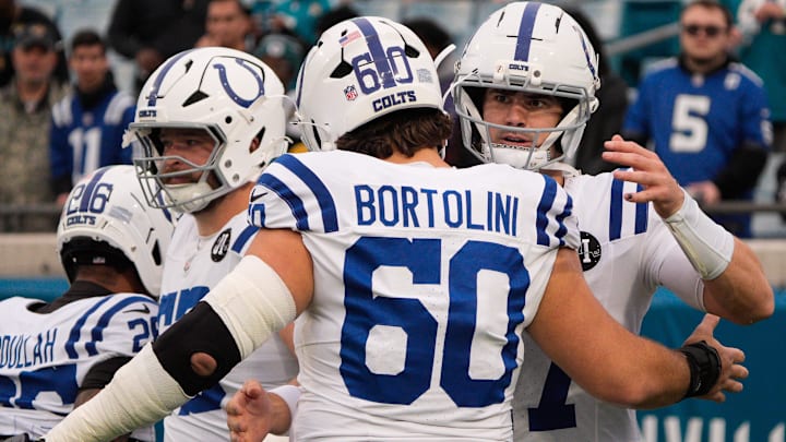 Indianapolis Colts quarterback Daniel Jones (17) gives Indianapolis Colts center Tanor Bortolini (60) a hug before an NFL football game at EverBank Stadium, Sunday, Dec. 7, 2025, in Jacksonville, Fla. [Doug Engle/Florida Times-Union]