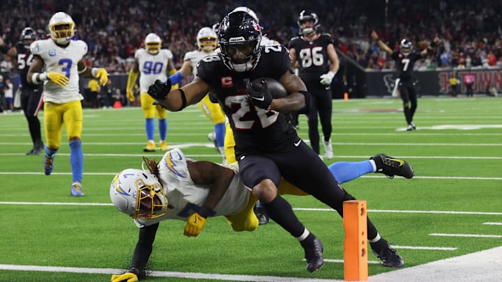 Jan 11, 2025; Houston, Texas, USA; Houston Texans running back Joe Mixon (28) scores a touchdown against the Los Angeles Chargers in the fourth quarter in an AFC wild card game at NRG Stadium. Mandatory Credit: Thomas Shea-Imagn Images Jan 11, 2025; Houston, Texas, USA; Houston Texans running back Joe Mixon (28) scores a touchdown against the Los Angeles Chargers in the fourth quarter in an AFC wild card game at NRG Stadium. Mandatory Credit: Thomas Shea-Imagn Images
