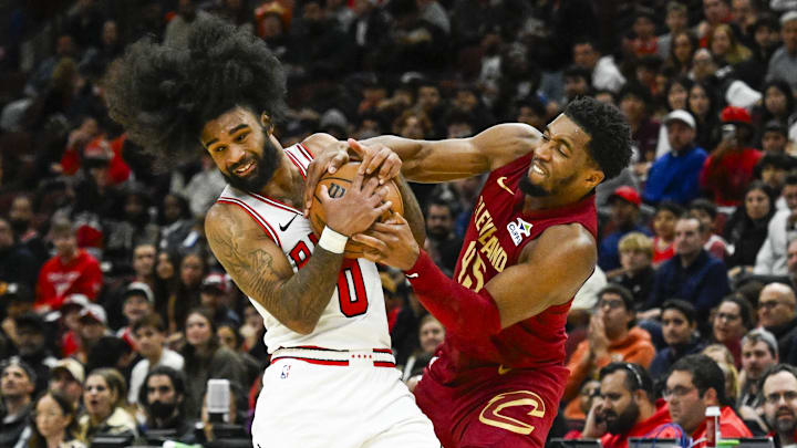 Oct 18, 2024; Chicago, Illinois, USA;  Chicago Bulls guard Coby White (0) and Cleveland Cavaliers guard Donovan Mitchell (45) fight for the ball during the second half at the United Center. Mandatory Credit: Matt Marton-Imagn Images