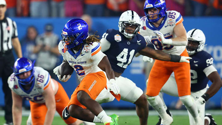 Dec 31, 2024; Glendale, AZ, USA; Boise State Broncos running back Ashton Jeanty (2) rushes the ball against the Penn State Nittany Lions during the first half in the Fiesta Bowl at State Farm Stadium. Mandatory Credit: Mark J. Rebilas-Imagn Images
