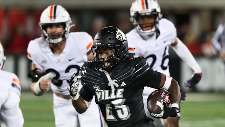 U of L's Jawhar Jordan (25) eludes Virginia defenders during their game at the L&N Stadium in Louisville, Ky. on Nov. 9, 2023.