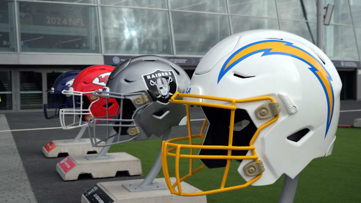 Oct 13, 2024; London, United Kingdom; Large helmets of the Los Angeles Chargers, Las Vegas Raiders, Kansas City Chiefs and Denver Broncos of the AFC West before an NFL International Series game at Tottenham Hotspur Stadium. Mandatory Credit: Kirby Lee-Imagn Images