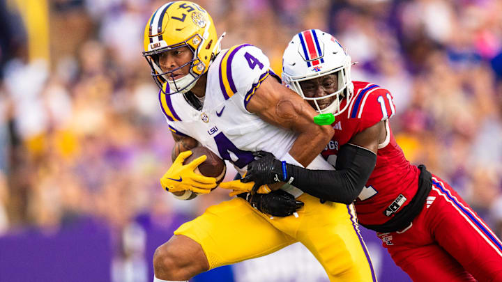 Sep 6, 2025; Baton Rouge, Louisiana, USA;  LSU Tigers wide receiver Nic Anderson (4) is tackled by Louisiana Tech Bulldogs defensive back Cedric Woods (11) during the first half against Louisiana Tech Bulldogs at Tiger Stadium. Mandatory Credit: Stephen Lew-Imagn Images