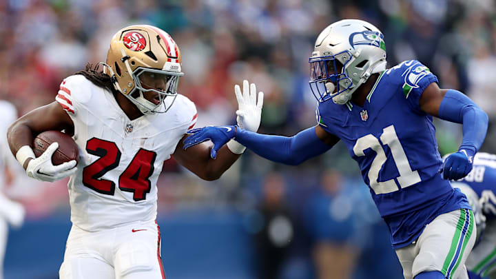 San Francisco 49ers running back Jordan Mason (L) and Seattle Seahawks cornerback Devon Witherspoon (R)