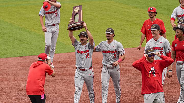 Jun 7, 2026; Athens, GA, USA; Georgia Bulldogs pitcher Caden Aoki (12) carries the Super Regional championship trophy after Georgia defeated the Mississippi State Bulldogs at Foley Field. Mandatory Credit: Dale Zanine-Imagn Images Jun 7, 2026; Athens, GA, USA; Georgia Bulldogs pitcher Caden Aoki (12) carries the Super Regional championship trophy after Georgia defeated the Mississippi State Bulldogs at Foley Field. Mandatory Credit: Dale Zanine-Imagn Images