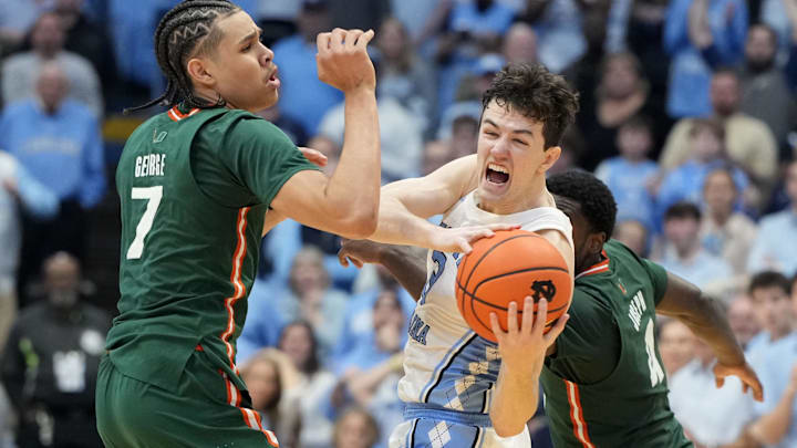 Feb 26, 2024; Chapel Hill, North Carolina, USA; North Carolina Tar Heels guard Cormac Ryan (3) with the ball as Miami (Fl) Hurricanes guards Kyshawn George (7) and  Bensley Joseph (4) defend in the second half at Dean E. Smith Center.