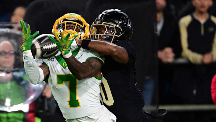 Oct 18, 2024; West Lafayette, Indiana, USA; Oregon Ducks wide receiver Evan Stewart (7) catches a long pass under coverage from Purdue Boilermakers defensive back Kyndrich Breedlove (10) during the first quarter at Ross-Ade Stadium. Mandatory Credit: Marc Lebryk-Imagn Images