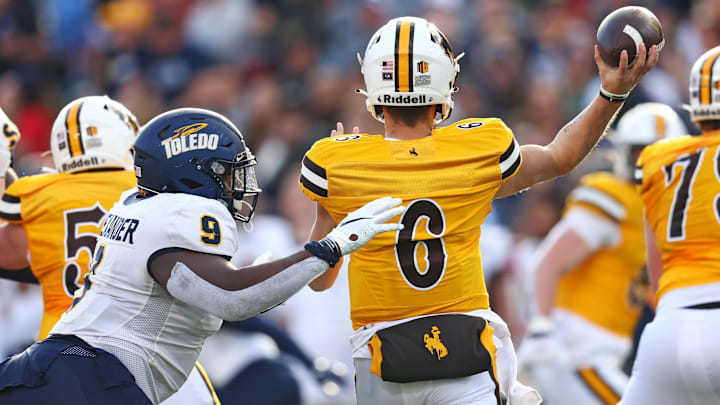 Dec 30, 2023; Tucson, AZ, USA; Wyoming Cowboys quarterback Andrew Peasley (6) throws a pass against Toledo Rockets defensive tackle Darius Alexander (9) during the second quarter in the Arizona Bowl at Arizona Stadium. Mandatory Credit: Mark J. Rebilas-Imagn Images Dec 30, 2023; Tucson, AZ, USA; Wyoming Cowboys quarterback Andrew Peasley (6) throws a pass against Toledo Rockets defensive tackle Darius Alexander (9) during the second quarter in the Arizona Bowl at Arizona Stadium. Mandatory Credit: Mark J. Rebilas-Imagn Images