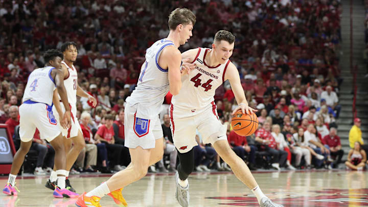Oct 25, 2024; Fayetteville, AR, USA; Arkansas Razorbacks forward Zvonimir Ivisic (44) drives against Kansas Jayhawks forward Zach Clemence (41) during the second half at Bud Walton Arena. Mandatory Credit: Nelson Chenault-Imagn Images