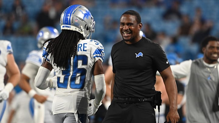 Aug 25, 2023; Charlotte, North Carolina, USA;  Detroit Lions cornerbacks coach Dre Bly reacts with cornerback Steven Gilmore (36) after Carolina Panthers turn the ball over in the fourth quarter at Bank of America Stadium. Mandatory Credit: Bob Donnan-Imagn Images