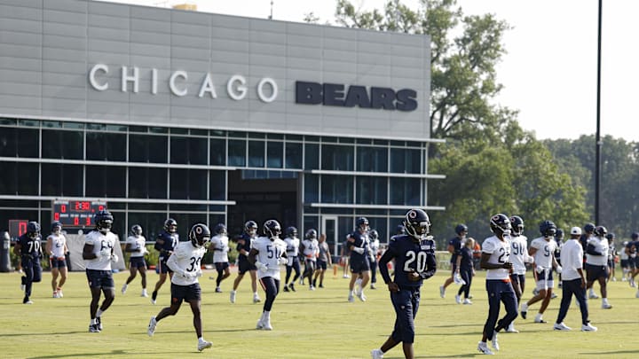 Bears players take the field for warmups prior to practice at  Halas Hall in Lake Forest, Ill.