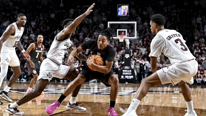Jan 10, 2026; College Station, Texas, USA; Oklahoma Sooners guard Nijel Pack (9) controls the ball as Texas A&M Aggies guard Rylan Griffen (3) and guard Jacari Lane (5)  defend during the second half at Reed Arena. Mandatory Credit: Maria Lysaker-Imagn Images 