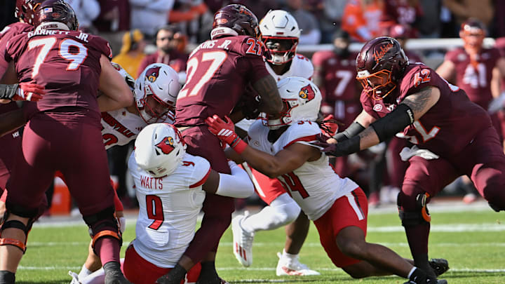 Nov 1, 2025; Blacksburg, Va.; Louisville defensive back Antonio Watts (9) tackles Virginia Tech running back Marcellous Hawkins (27).