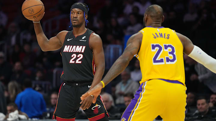 Dec 4, 2024; Miami, Florida, USA;  Miami Heat forward Jimmy Butler (22) looks to pass against Los Angeles Lakers forward LeBron James (23) in the first half at Kaseya Center. Mandatory Credit: Jim Rassol-Imagn Images