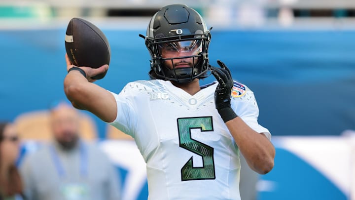 Jan 1, 2026; Miami Gardens, FL, USA; Oregon Ducks quarterback Dante Moore (5) warms up prior to the 2025 Orange Bowl and quarterfinal game of the College Football Playoff against the Texas Tech Red Raiders at Hard Rock Stadium. Mandatory Credit: Sam Navarro-Imagn Images
