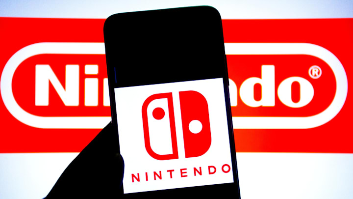 In this photo illustration, a Nintendo logo seen displayed...